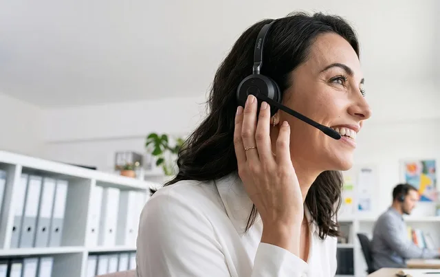 office, headset, smiling woman, headset microphone, workplace, interaction, call center, conversation, professional, communication, customer service, woman, smile, white shirt, satisfaction, working, happy worker, administrative, telephone call. When to turn your customer success software selection checklist into a scorecard